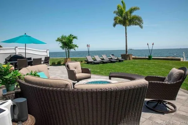 a view of a patio with couches under an umbrella