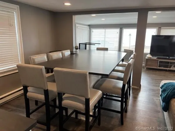 a view of a dining room with furniture and wooden floor