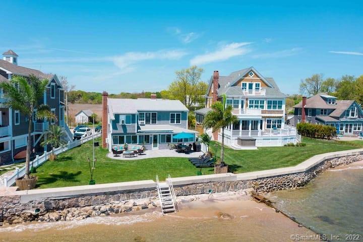 21 Grove Way, Unit 21 Clinton, CT 06413 - Photo 25 of 37 a front view of a house with a yard and potted plants