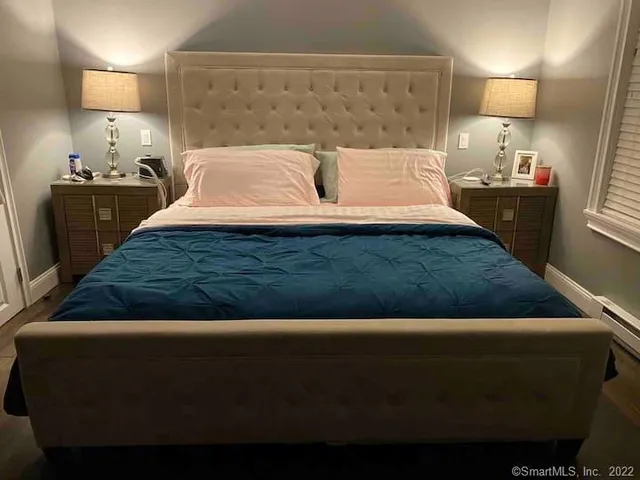 a bedroom with a bed and window