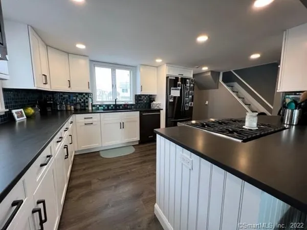 a kitchen with lots of counter space and wooden floor