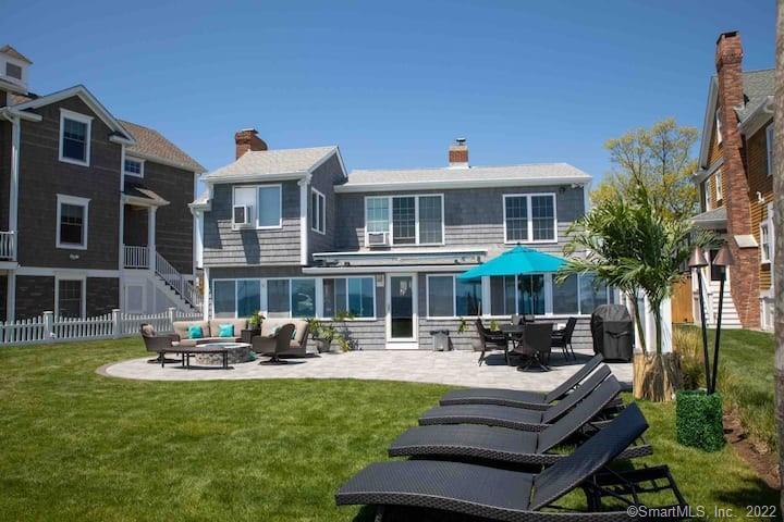 21 Grove Way, Unit 21 Clinton, CT 06413 - Photo 28 of 37 a front view of a building with garden and trees