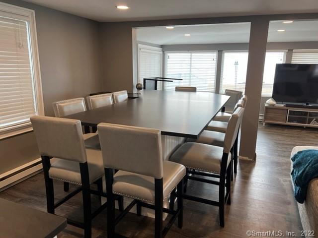 21 Grove Way, Unit 21 Clinton, CT 06413 - Photo 3 of 37 a view of a dining room with furniture and wooden floor
