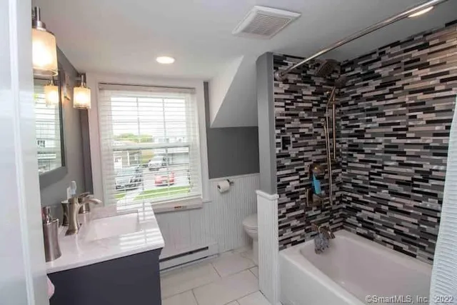 a bathroom with a bathtub a sink and a shower