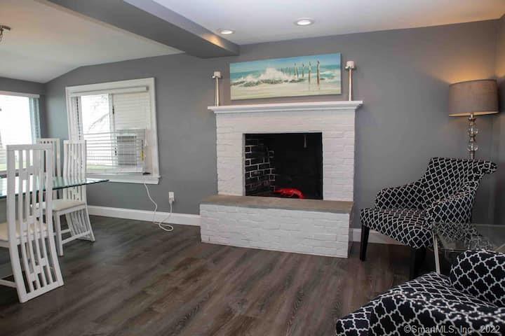 21 Grove Way, Unit 21 Clinton, CT 06413 - Photo 31 of 37 a living room with furniture and a fireplace