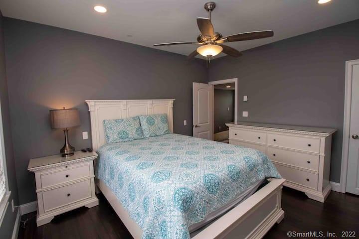 21 Grove Way, Unit 21 Clinton, CT 06413 - Photo 32 of 37 a bedroom with a bed and a chandelier