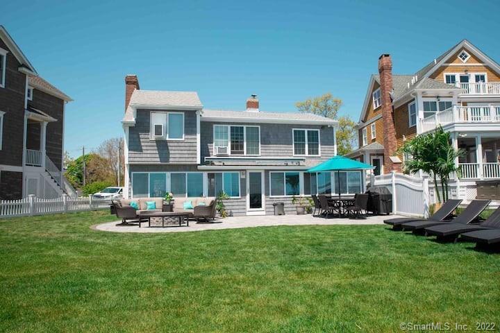 21 Grove Way, Unit 21 Clinton, CT 06413 - Photo 32 of 37 a front view of a house with garden and sitting area