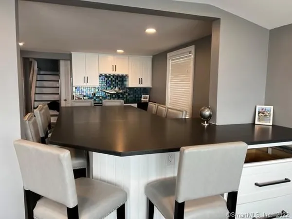 a kitchen with a table chairs and a dining table