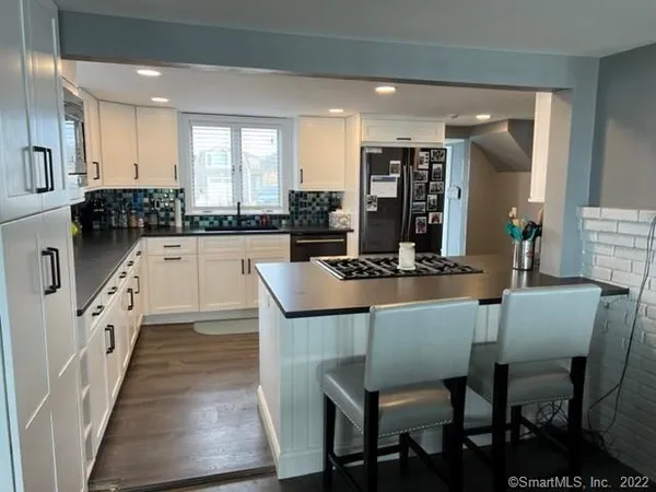 a kitchen with a table chairs sink and cabinets