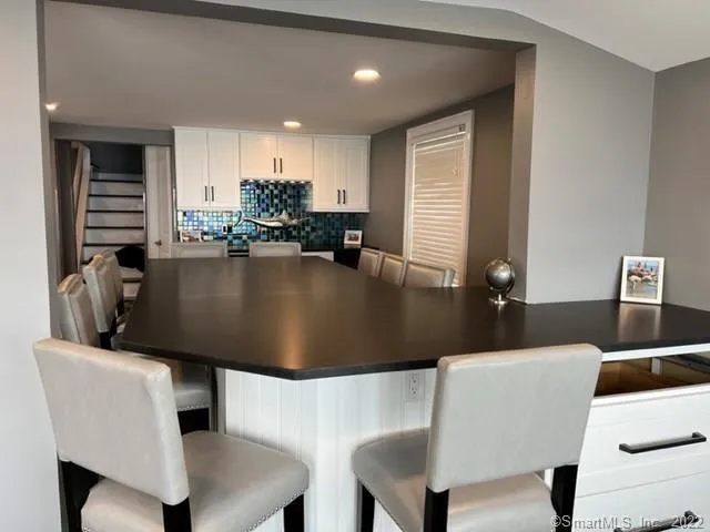 a kitchen with a table chairs and a dining table