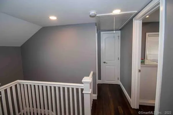 a view of hallway with wooden floor