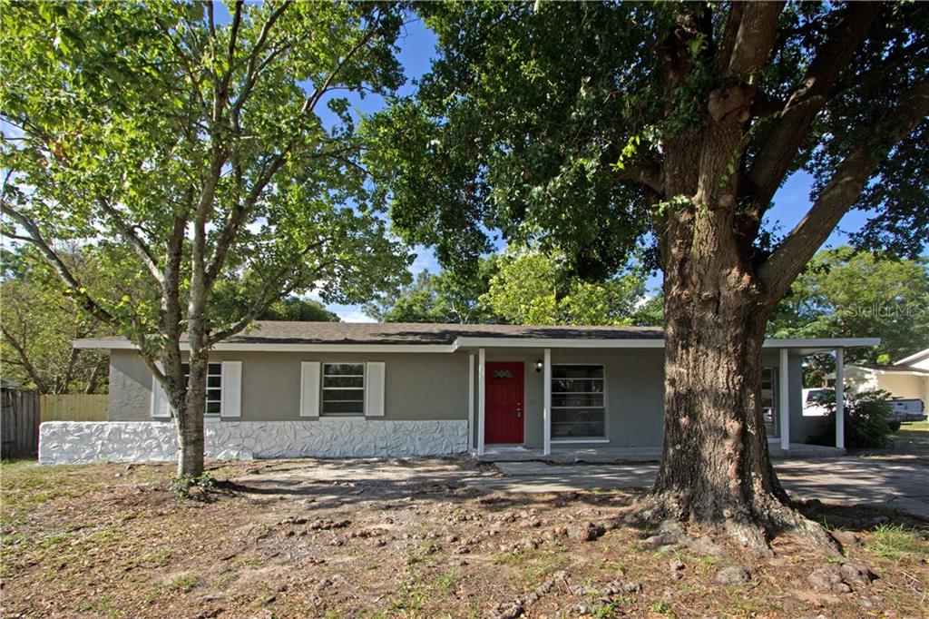 6210 Fox Hunt Trail Orlando, FL 32808 - Photo 1 of 1 a front view of a house with a tree