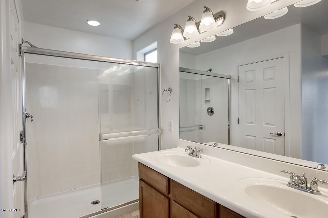 1958 West Davis Road Phoenix, AZ 85023 - Photo 14 of 25 a bathroom with a sink mirror and a shower