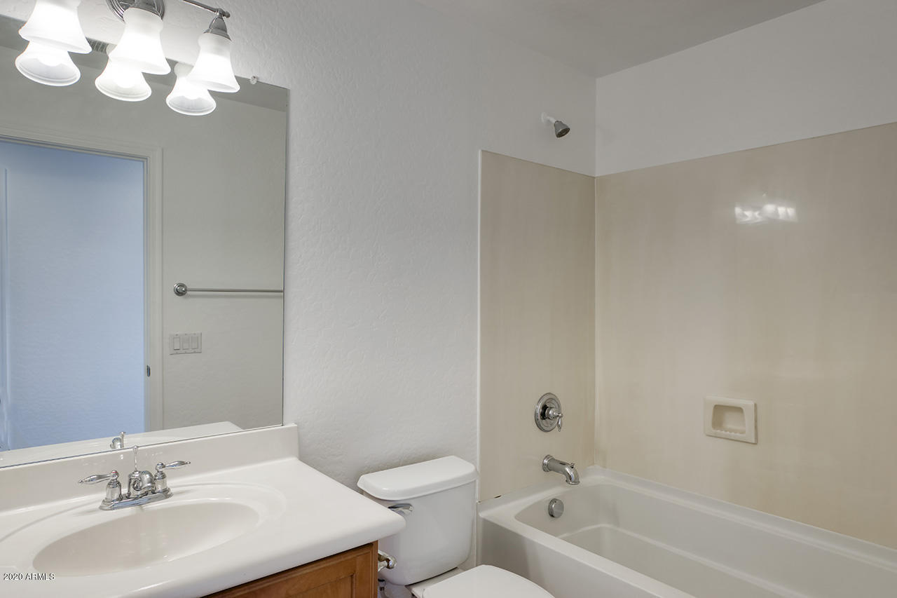 1958 West Davis Road Phoenix, AZ 85023 - Photo 18 of 25 a bathroom with a sink a toilet and a bathtub