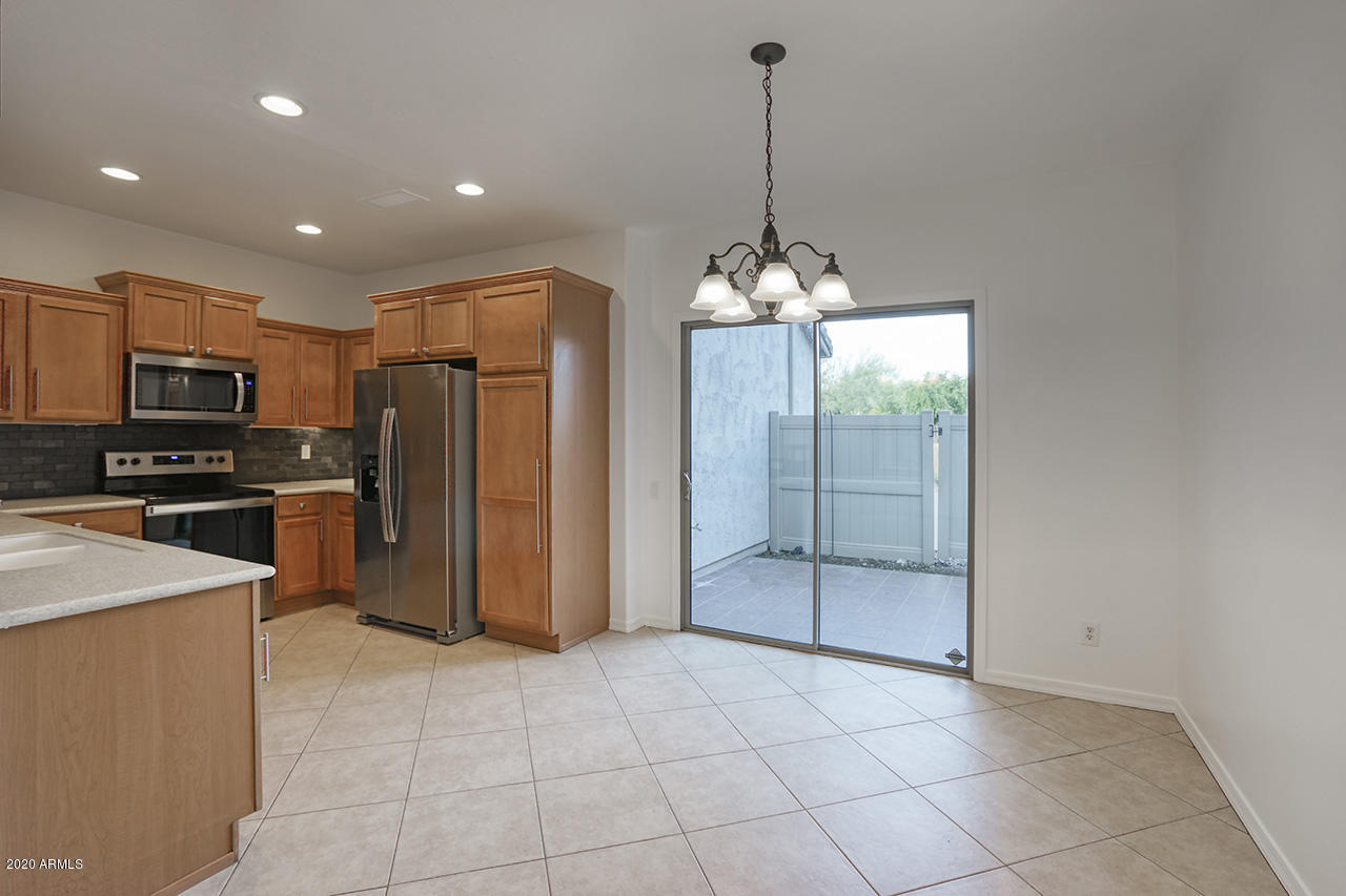 1958 West Davis Road Phoenix, AZ 85023 - Photo 6 of 25 a view of a kitchen with a sink and stainless steel appliances
