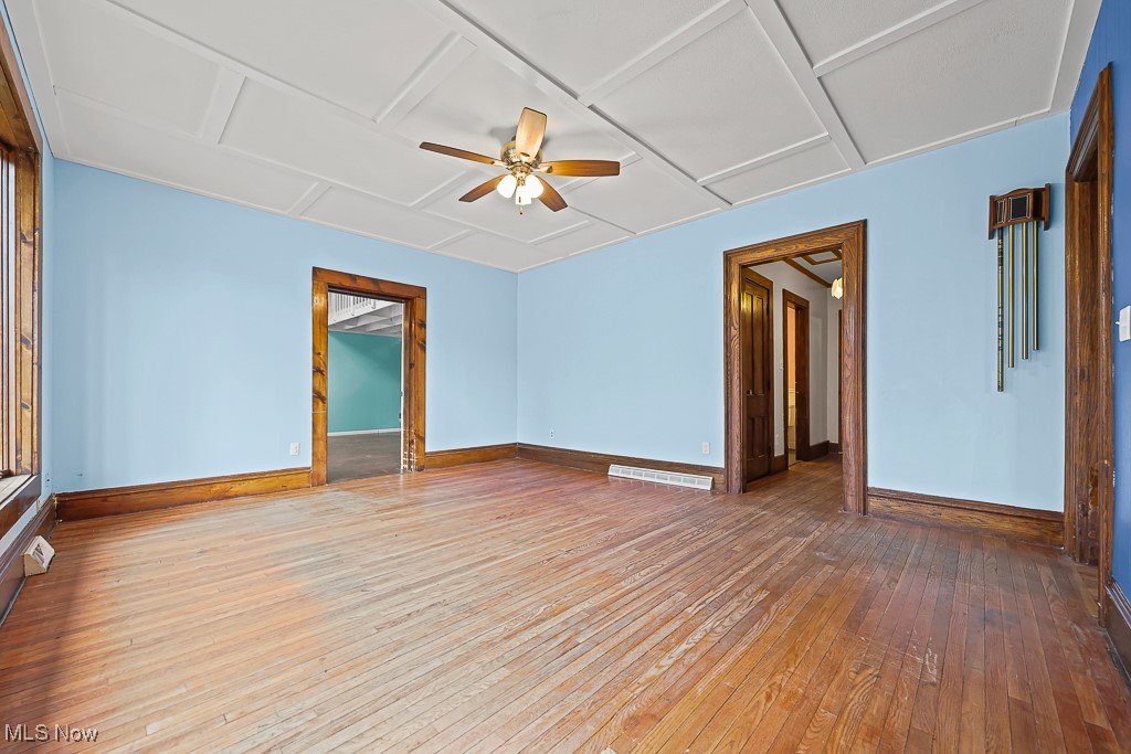 3401 Waterloo Road Mogadore, OH 44260 - Photo 13 of 50 Empty room with light wood-style flooring, attic access, and a ceiling fan
