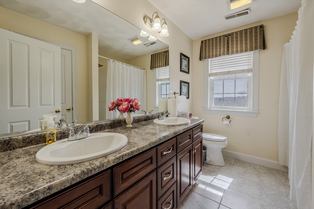 9 Kettle Way Dracut, MA 01826 - Photo 15 of 19 a bathroom with a granite countertop sink a toilet and a mirror