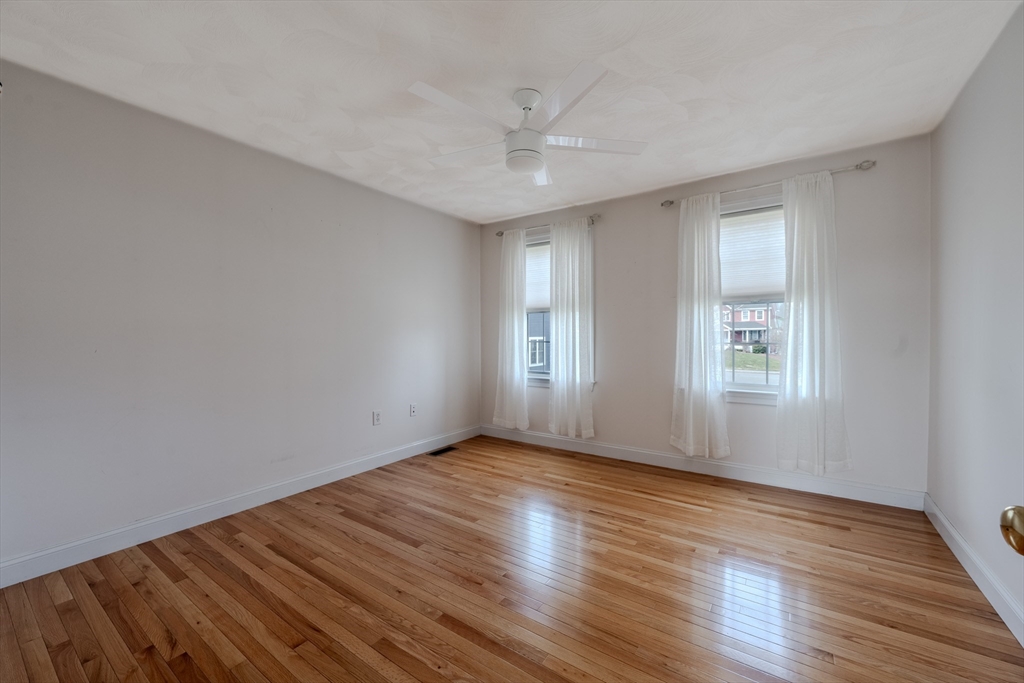 9 Kettle Way Dracut, MA 01826 - Photo 17 of 19 a view of an empty room with wooden floor and a window