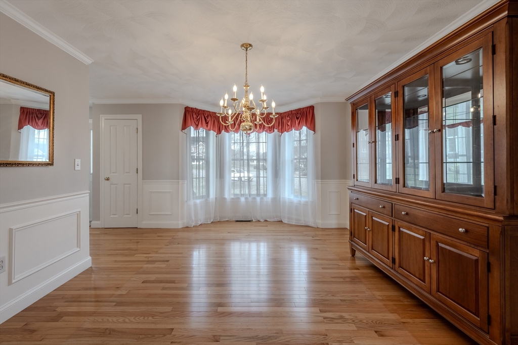 9 Kettle Way Dracut, MA 01826 - Photo 4 of 19 a view of an entryway with wooden floor and chandelier