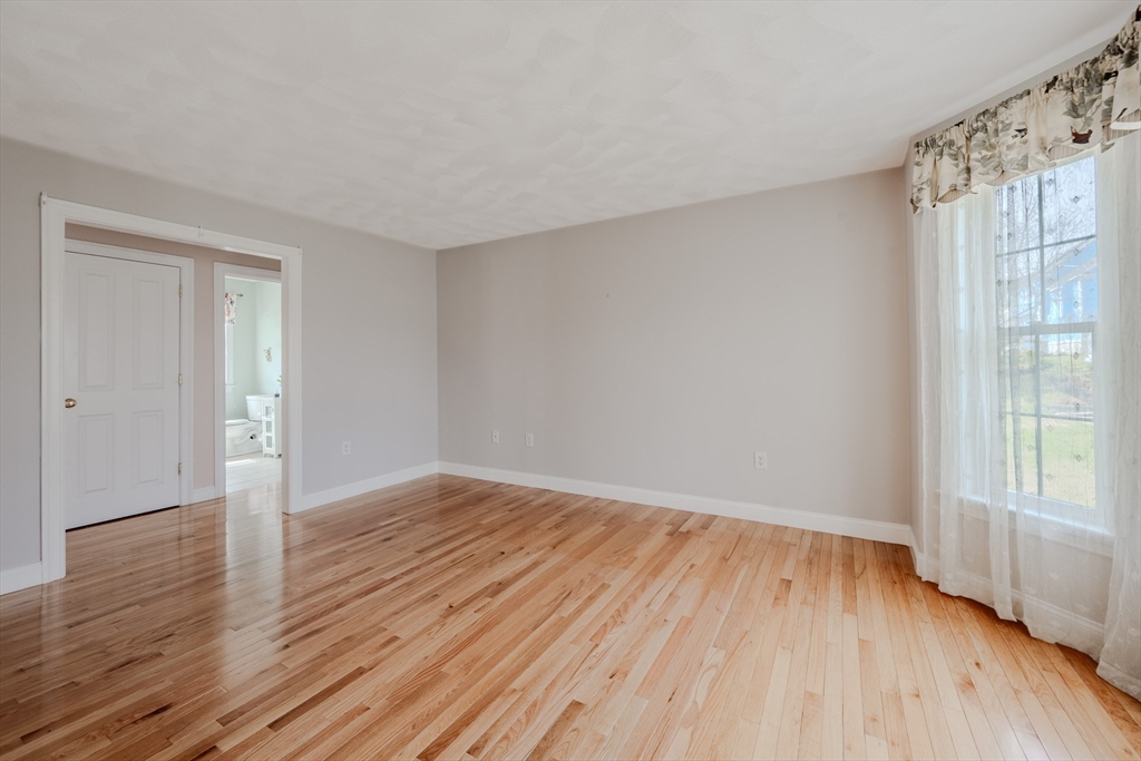 9 Kettle Way Dracut, MA 01826 - Photo 5 of 19 a view of an empty room with wooden floor and a window