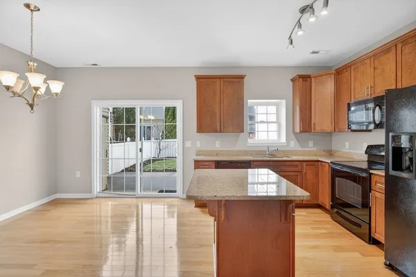 a sink with granite countertop white cabinets and a sink