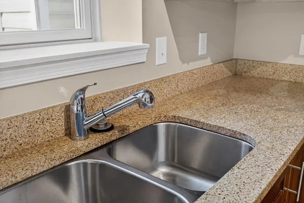 a stove top oven sitting inside of a kitchen