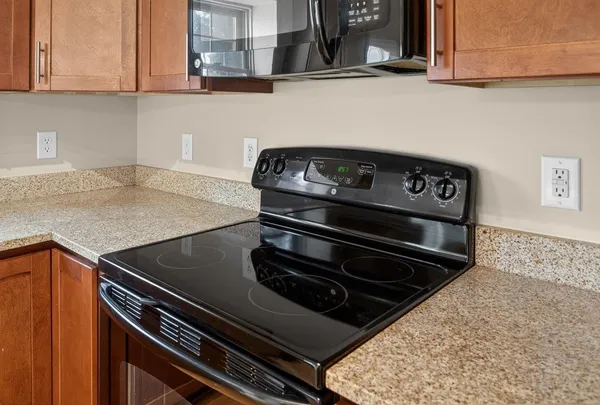 a kitchen with stainless steel appliances kitchen island a refrigerator and cabinets