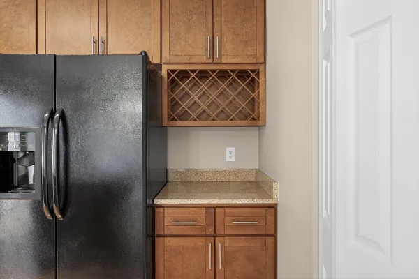 a kitchen with a refrigerator a sink dishwasher a oven with a dining table and chairs