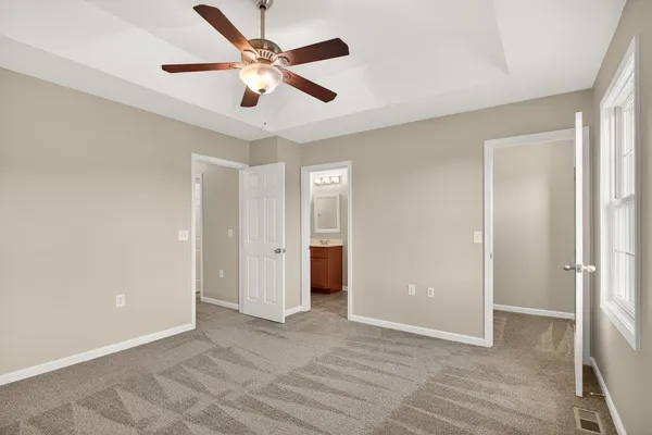 a view of an empty room with a ceiling fan
