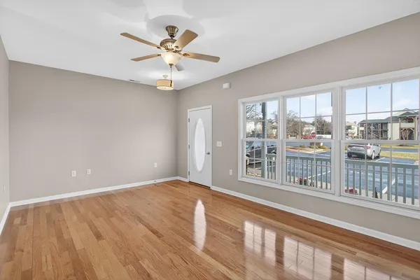 wooden floor in an empty room with a window