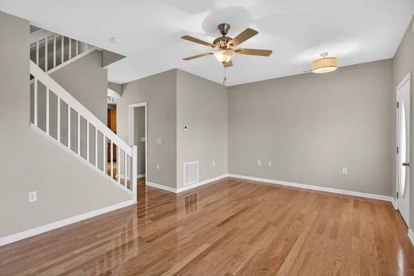 wooden floor in an empty room with a window