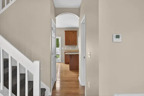 a view of staircase with wooden floor and white walls
