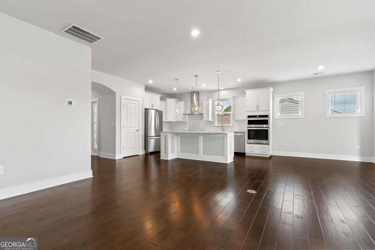 1061 Little Shls Road Greensboro, GA 30642 - Photo 11 of 41 a view of a kitchen with wooden floor and a kitchen