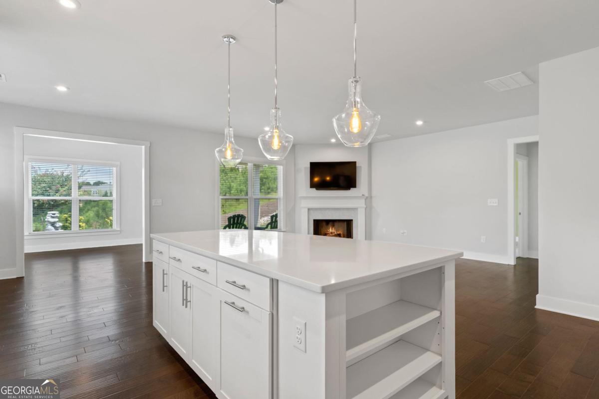 1061 Little Shls Road Greensboro, GA 30642 - Photo 16 of 41 a view of cabinets a sink and a fireplace