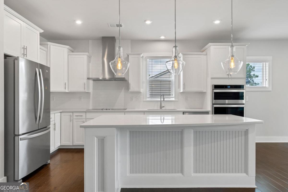1061 Little Shls Road Greensboro, GA 30642 - Photo 19 of 41 a kitchen with stainless steel appliances granite countertop a refrigerator a sink and a stove