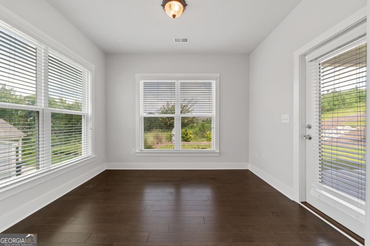 1061 Little Shls Road Greensboro, GA 30642 - Photo 20 of 41 a view of an empty room with wooden floor and a window