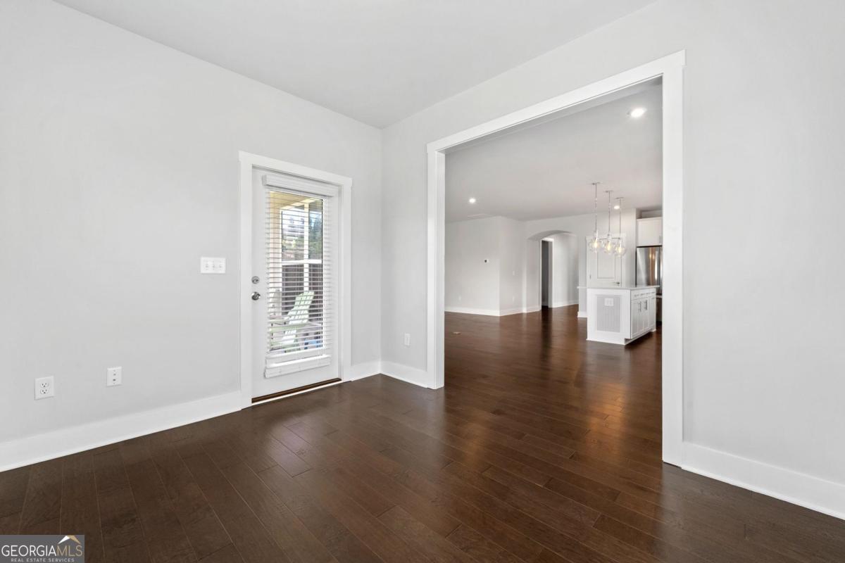 1061 Little Shls Road Greensboro, GA 30642 - Photo 21 of 41 an empty room with wooden floor and a bathroom