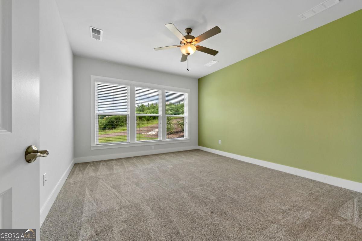 1061 Little Shls Road Greensboro, GA 30642 - Photo 22 of 41 an empty room with a window