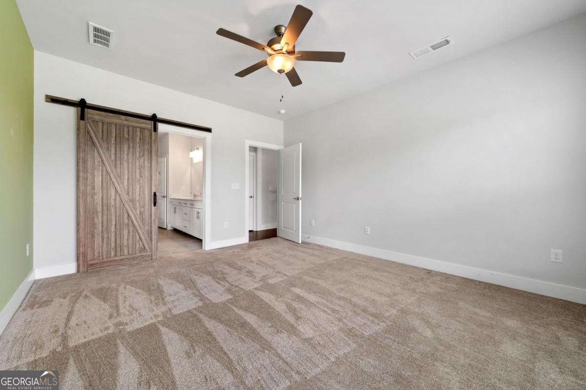 1061 Little Shls Road Greensboro, GA 30642 - Photo 23 of 41 wooden floor in an empty room