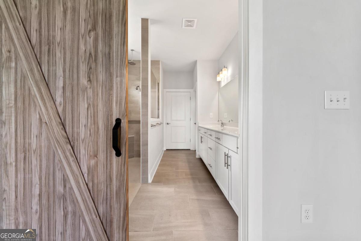 1061 Little Shls Road Greensboro, GA 30642 - Photo 24 of 41 a bathroom with a double vanity sink and tub