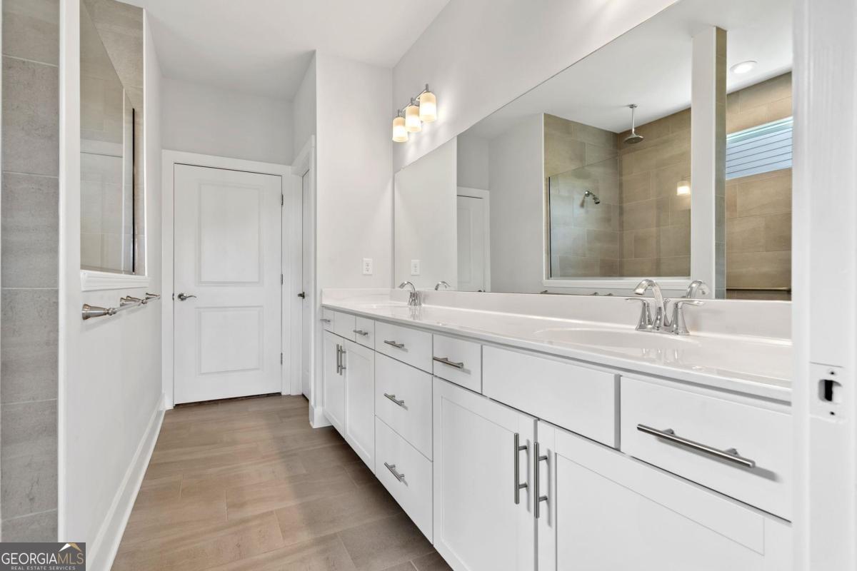 1061 Little Shls Road Greensboro, GA 30642 - Photo 25 of 41 a spacious bathroom with 2 sink and a mirror