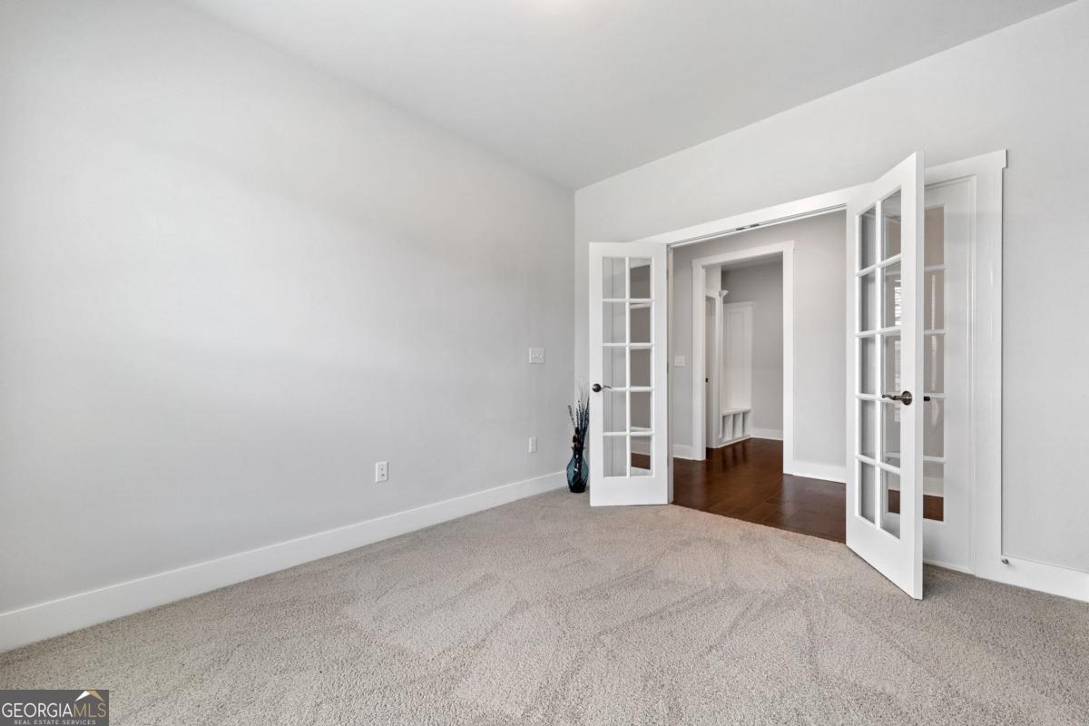 1061 Little Shls Road Greensboro, GA 30642 - Photo 29 of 41 a view of empty room with wooden floor and closet