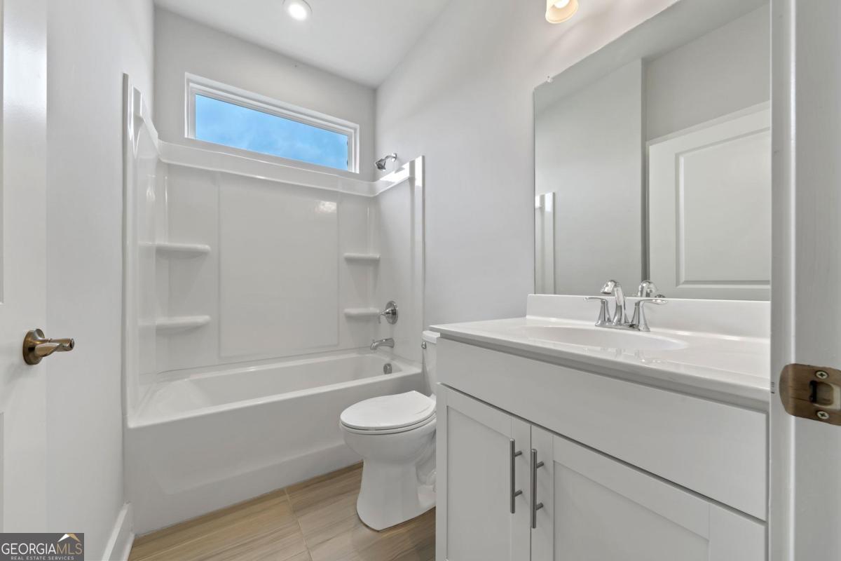 1061 Little Shls Road Greensboro, GA 30642 - Photo 30 of 41 a bathroom with a sink a toilet and shower
