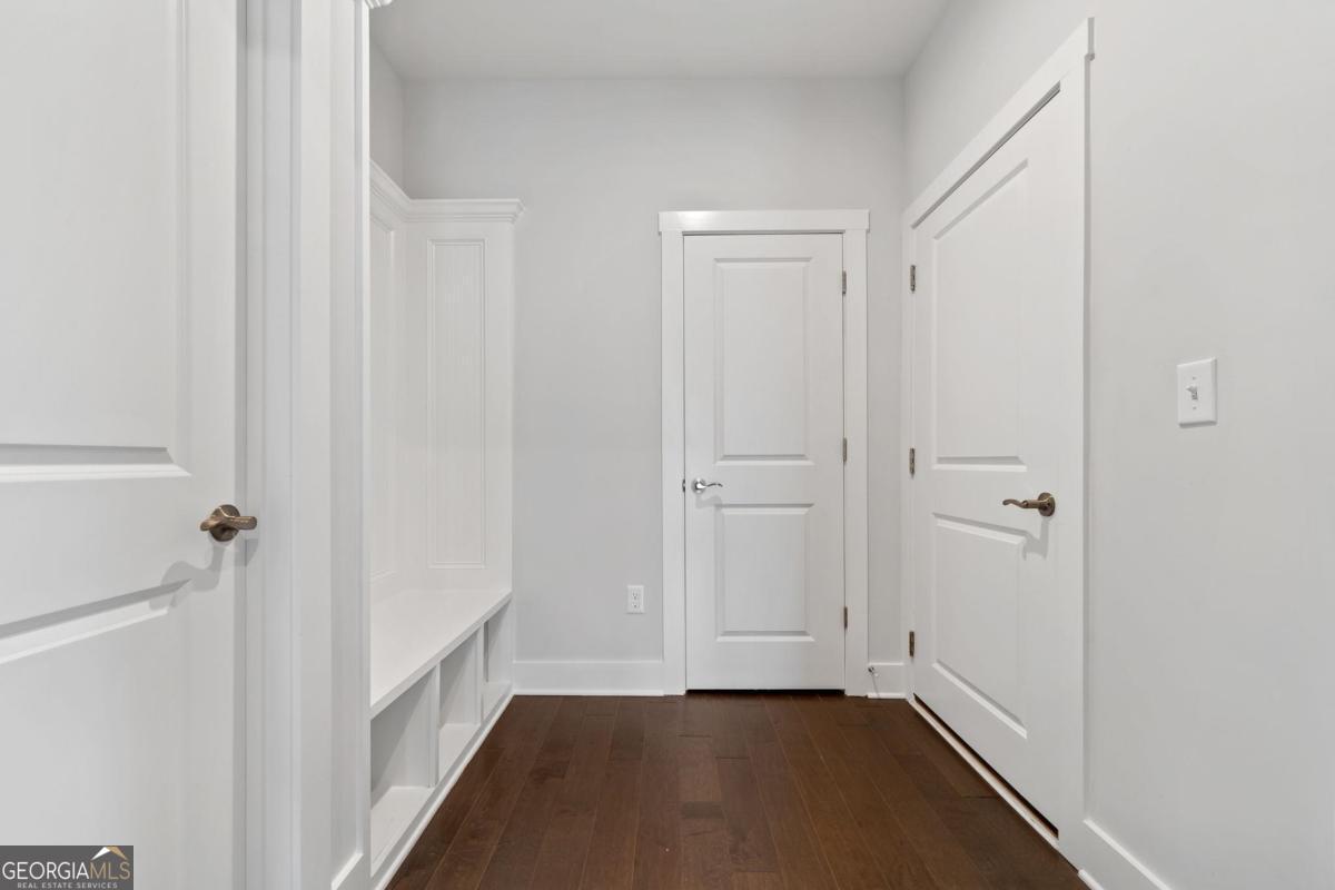1061 Little Shls Road Greensboro, GA 30642 - Photo 31 of 41 a view of a hallway with wooden floor