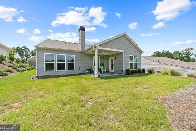 a front view of a house with yard and green space