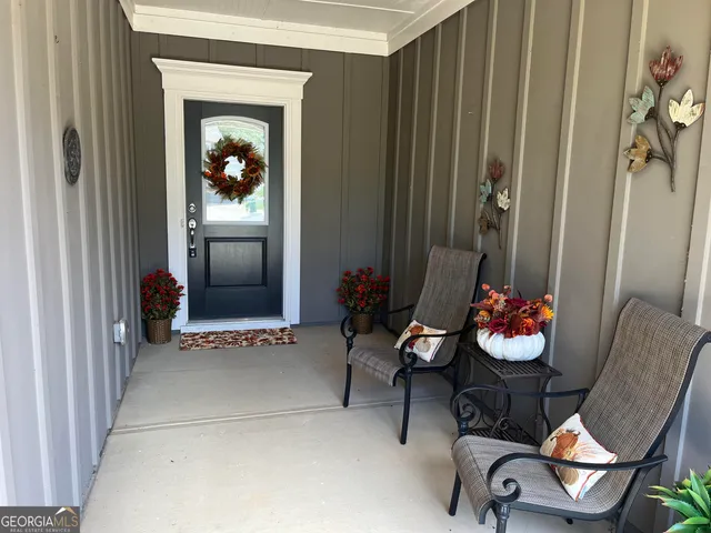 a living room with furniture and flowers
