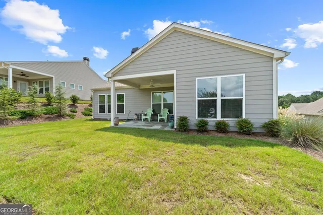 a front view of house with yard and outdoor seating