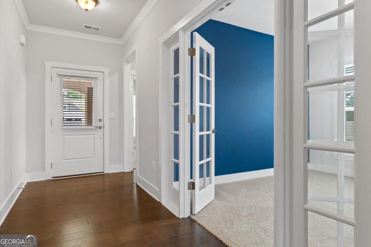 1061 Little Shls Road Greensboro, GA 30642 - Photo 6 of 41 a view of a livingroom with wooden floor and a hallway