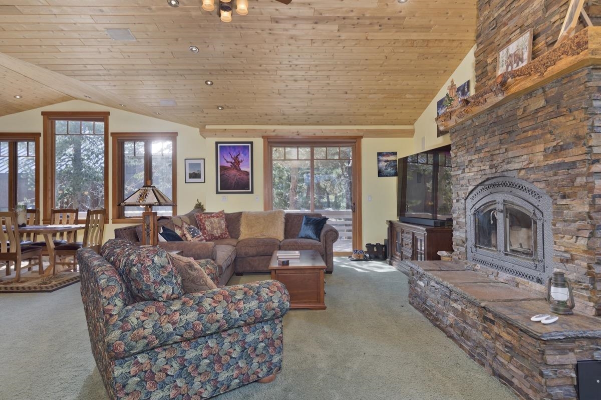 2500 Old Mammoth Road Mammoth Lakes, CA 93546 - Photo 7 of 48 a living room with furniture a fireplace and large windows