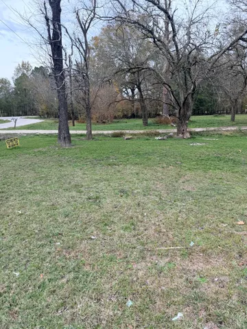 a view of grassy field with benches